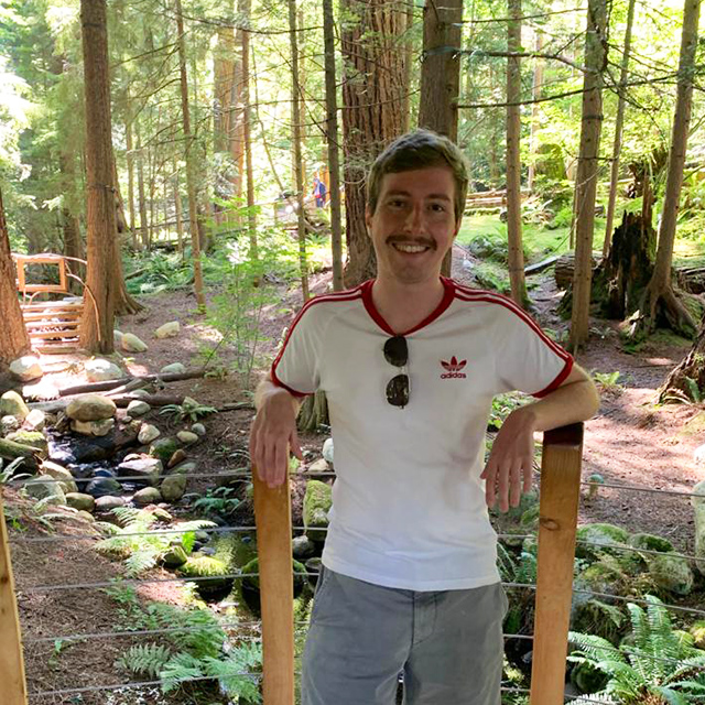 Eddie infront of a lush green forest