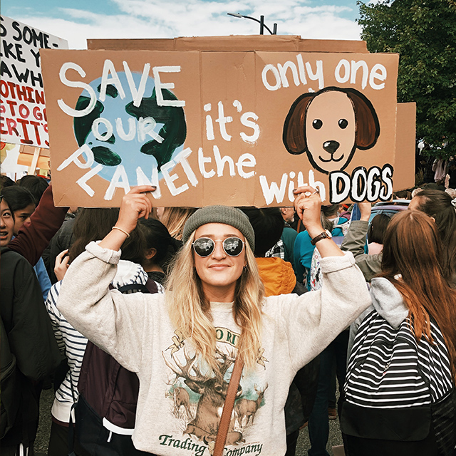 Katria with a poster wearing sunglasses