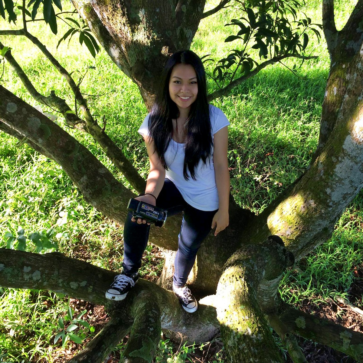 Kim sitting on a tree