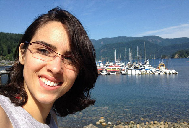 Photo of Livia infront of a shore with boats