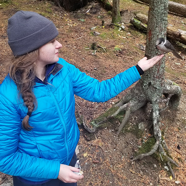 Photo of Megan with a bird on her hand