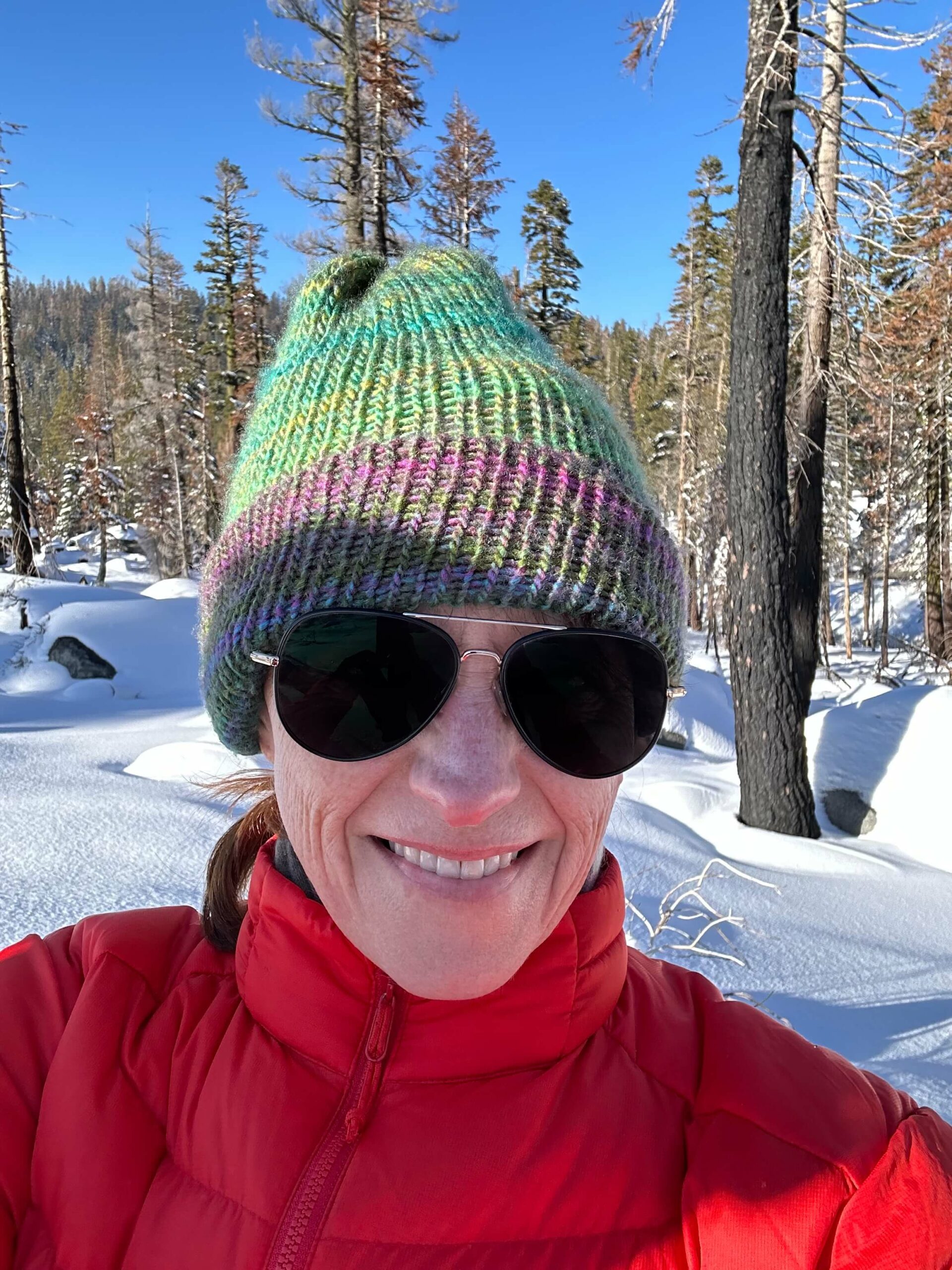 Wendy with sunglasses on a snowy landscape